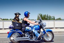 cruising in style on the blue Harley Davidson with matching helmet, in blue camo pants and mate with matching goggles along Tauranga Harbour Bridge